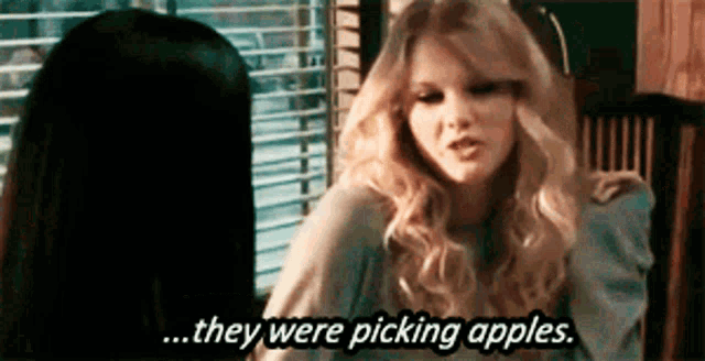 two women are sitting at a table and one of them says they were picking apples
