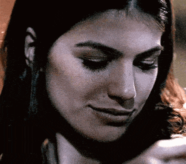 a close up of a woman 's face looking down