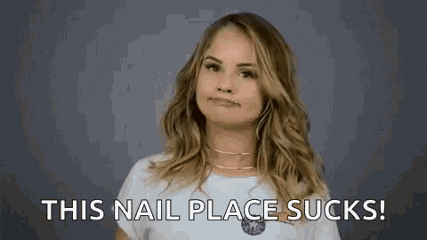 a woman is making a face and says `` this nail place sucks '' .