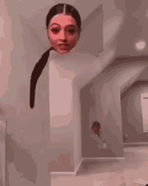 a woman 's head is sticking out of a wall in a living room .