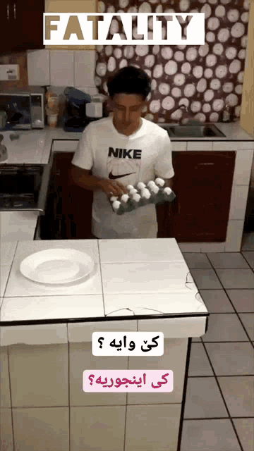 a man in a nike shirt holds a tray of eggs in a kitchen