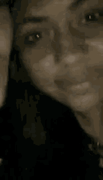 a close up of a woman 's face with her eyes closed and her mouth open .