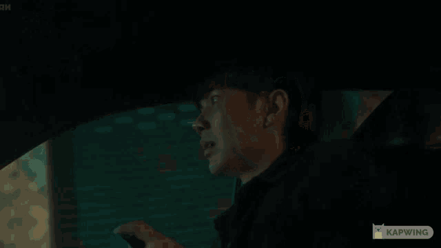 a man in a car is smiling and says " started " in yellow