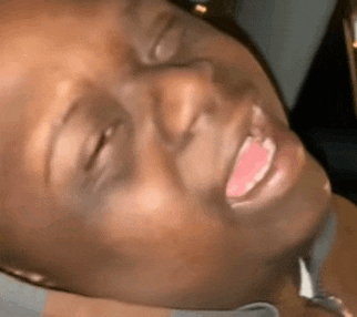 a close up of a woman 's face with her mouth open and her eyes closed .