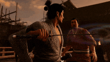 a man in a kimono kicks another man in the face