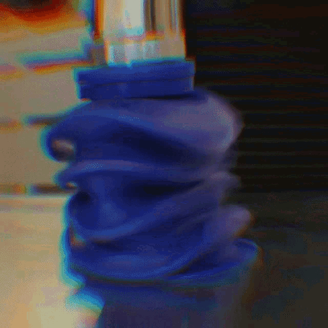 a blurry picture of a blue object that looks like a swirl