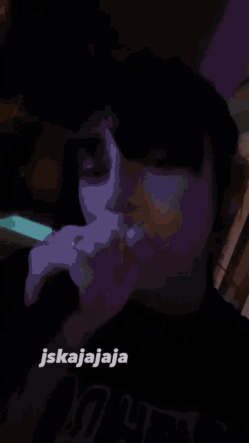 a woman singing into a microphone with a caption that says jskajaja