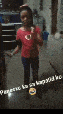 a little girl in a pink shirt is standing in a kitchen with the words " panesxc ka sa kapatid ko " on the bottom