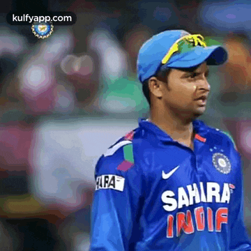 a man wearing a blue sahara india jersey and a blue hat .
