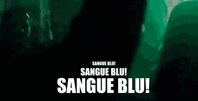 a group of people standing in a dark room with the words sangue blu written on the bottom .