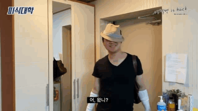 a man wearing a hat and gloves is standing in a doorway .
