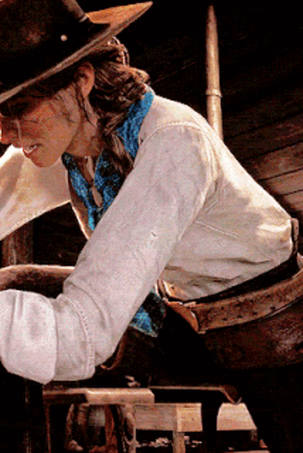 a woman wearing a cowboy hat and a bandana