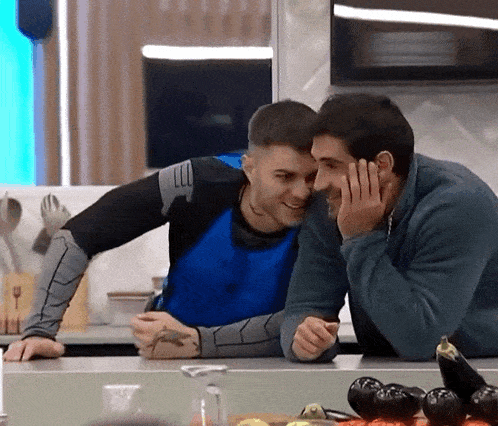 two men are sitting at a counter and one of them has a tattoo on his arm that says " lll "