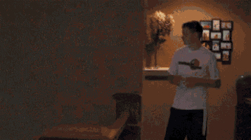 a man is standing in the doorway of a house