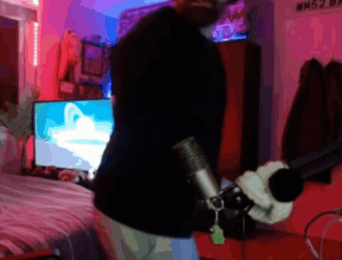 a blurry picture of a man holding a microphone in front of a sign that says wn52 on it