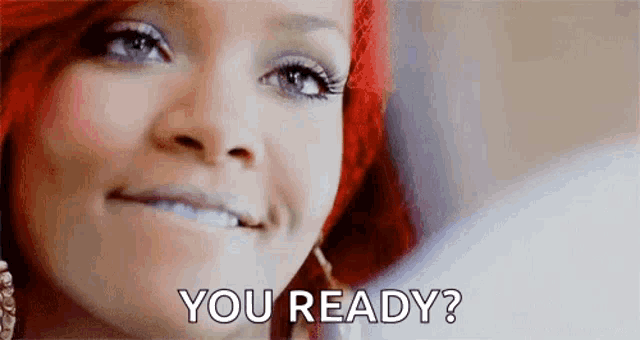 a woman with red hair is smiling and saying `` you ready '' .