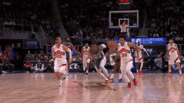 a basketball game is being played in front of a crowd at the courtside club