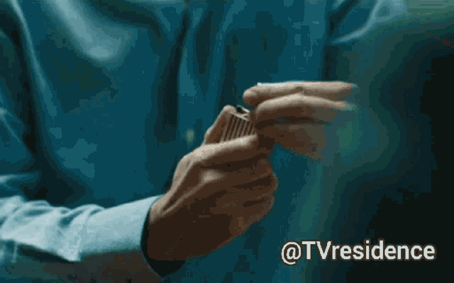 a close up of a person 's hands with the words @tvresidence below