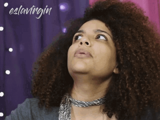 a woman with curly hair is looking up with the words eslovingin written on the bottom