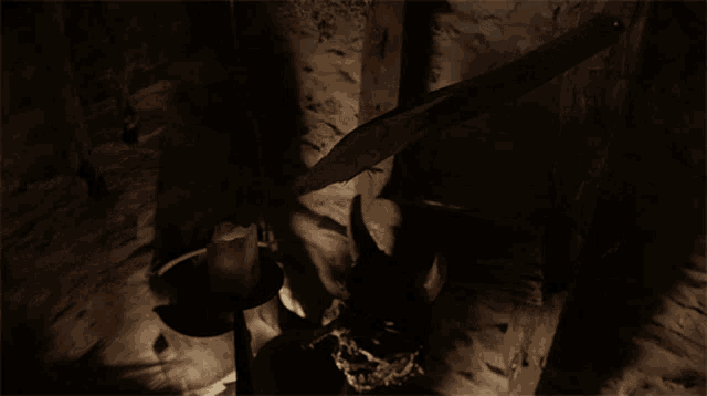 a dark room with a candle and a statue of a lion