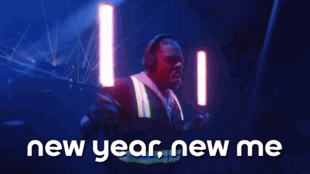a man in a safety vest is holding two lightsabers and the words new year new me are above him