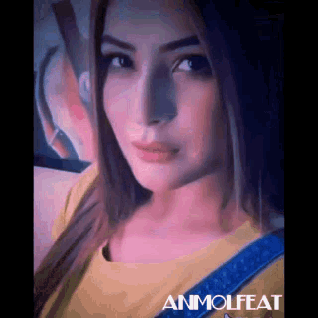 a close up of a woman 's face with the word ammolfeat written on the bottom