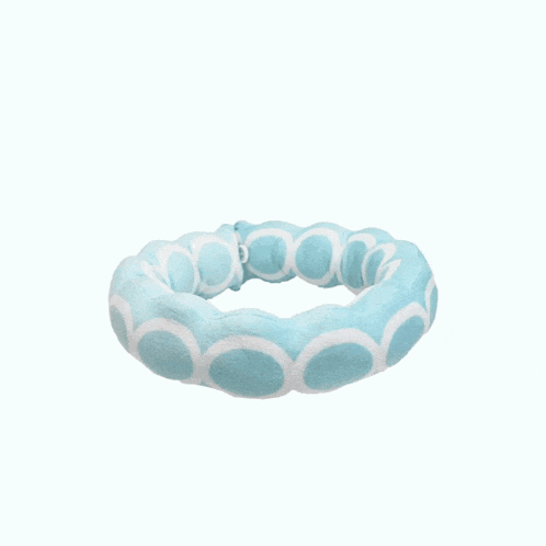 a blue and white ring with circles on it on a white background