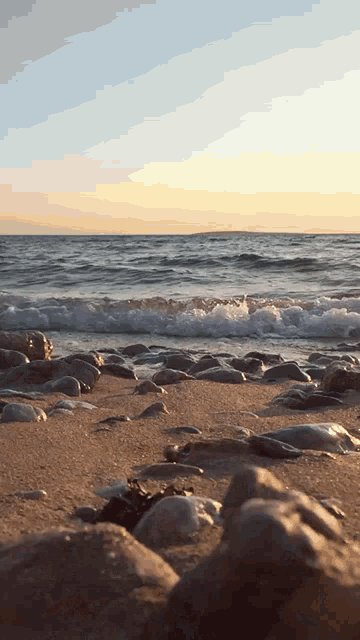 a rocky beach with waves crashing on the shore