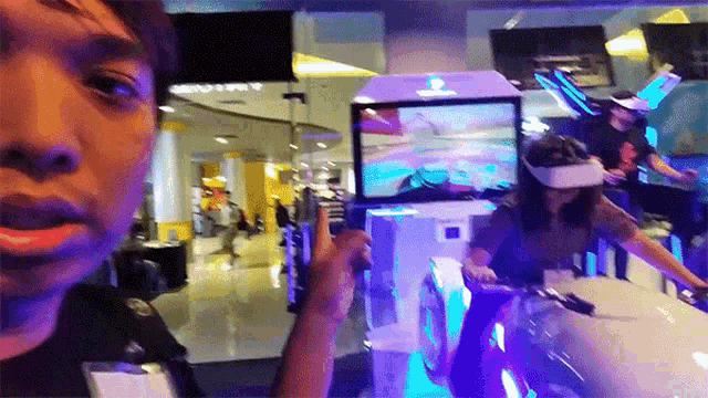a woman wearing a virtual reality headset is pointing at a screen