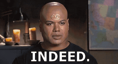a bald man with a medallion on his forehead is saying indeed .