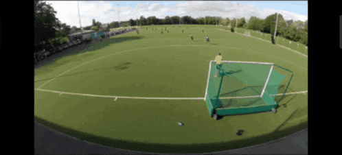 a blurry picture of a soccer field with a goal