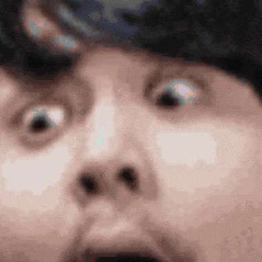 a close up of a man 's face with his mouth open