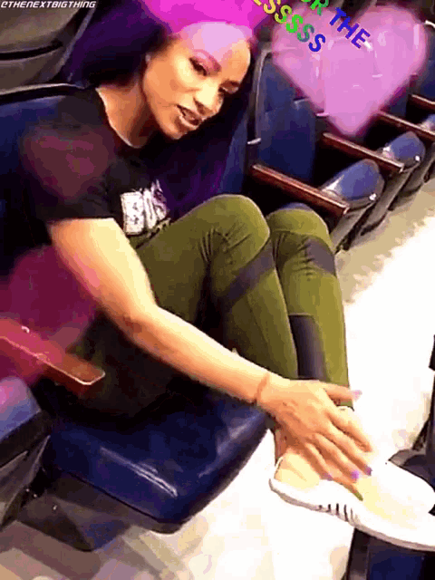 a woman is sitting in a chair with a purple heart in the background that says ' sss '