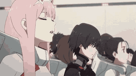 a couple of anime characters sitting next to each other in a room .
