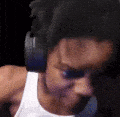 a man wearing headphones and a white tank top