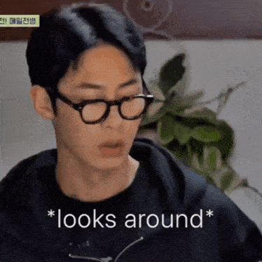 a young man wearing glasses and a black shirt says * looks around *