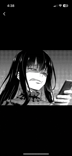 a black and white photo of a girl holding a cell phone and smiling .
