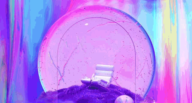 a snow globe with a chair inside of it
