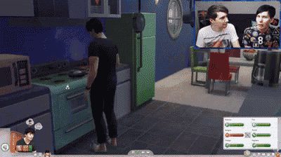 a man in a black shirt is standing in a kitchen in front of a green refrigerator