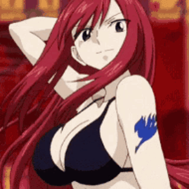 a woman with red hair is wearing a black bra