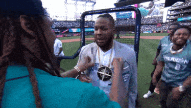 a man wearing a blue shirt that says ' merichan ' on it