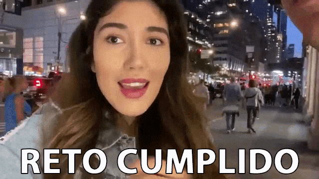 a woman is standing on a city street with the words " reto cumplido " written on the bottom
