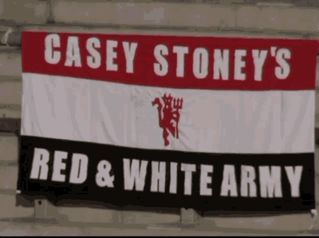 a casey stoney 's red and white army banner hangs on a wall