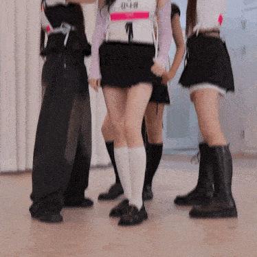 a group of girls are dancing together in a dance studio .