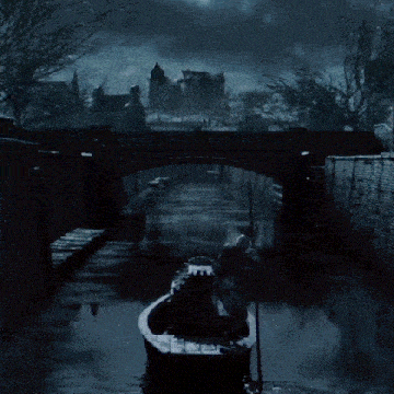 a man in a boat is going under a bridge