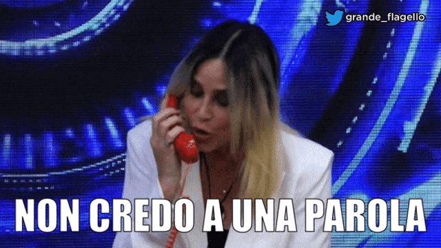 a woman talking on a phone with the words non credo a una parola