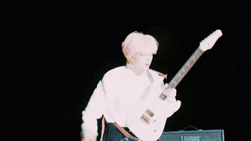 a person playing a guitar with a sticker on it that says ' fender '