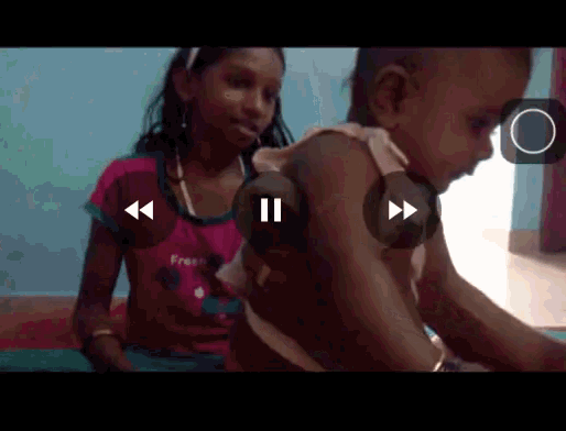 a girl in a pink shirt with the word free on it is holding a baby