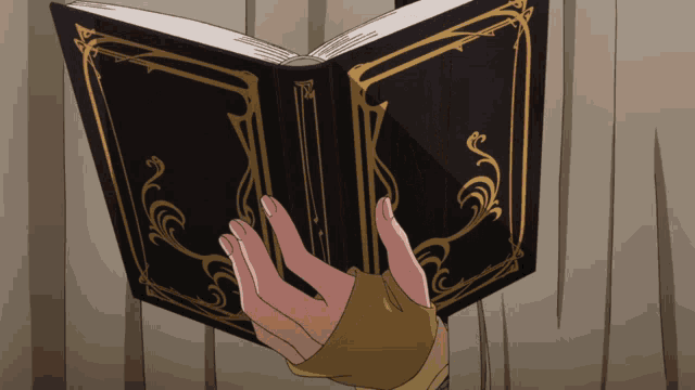 a person is holding a book with a gold border