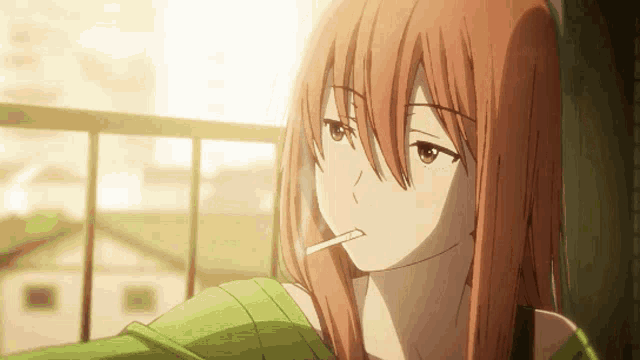 a girl with red hair is smoking a cigarette on a balcony